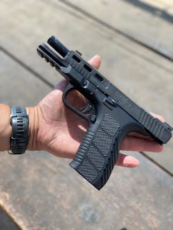 Not only are the controls familiar to the Glock user, most of the parts are interchangable with a Glock 17. Notice the lightening cuts and milled out section of the slide. Our tests showed that this improved the handling of the gun. Not only are the controls familiar to the Glock user, most of the parts are interchangable with a Glock 17. Notice the lightening cuts and milled out section of the slide. Our tests showed that this improved the handling of the gun.