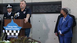 John Catanzara, president of the Chicago Fraternal Order of Police Lodge 7, addresses attendees as Mayor Lori Lightfoot watches during the unveiling of names for five Chicago police officers at the Gold Star Families Memorial and Park in September.