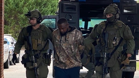 Members of Georgia's SWAT unit take Damien Anthony Ferguson into custody Sunday.