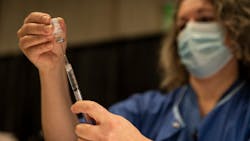 Registered nurse Kelly Beckley preps vials of the Pfizer COVID-19 vaccine to be administered to teachers and educators at The Oregon Convention Center on Jan. 27 in Portland. Registered nurse Kelly Beckley preps vials of the Pfizer COVID-19 vaccine to be administered to teachers and educators at The Oregon Convention Center on Jan. 27 in Portland.