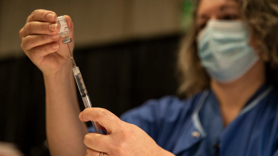 Registered nurse Kelly Beckley preps vials of the Pfizer COVID-19 vaccine to be administered to teachers and educators at The Oregon Convention Center on Jan. 27 in Portland.