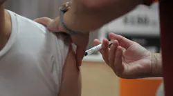 A person receives the COVID-19 vaccine in Camden, NJ, in August.