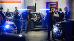 Officers examine a car at the scene where two Chicago police officers were shot on the 8000 block of Ogden Avenue on Wednesday in Lyons.