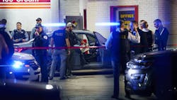 Officers examine a car at the scene where two Chicago police officers were shot on the 8000 block of Ogden Avenue on Wednesday in Lyons. Officers examine a car at the scene where two Chicago police officers were shot on the 8000 block of Ogden Avenue on Wednesday in Lyons.