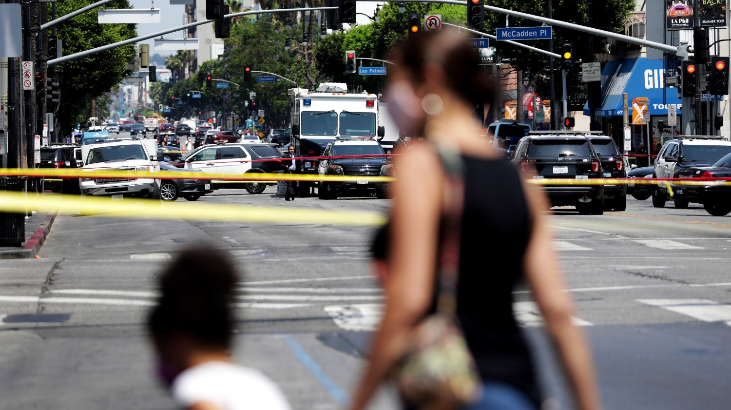 Pedestrians are turned around at the intersection of Hollywood Boulevard and Highland Avenue while Los Angeles police investigate an officer-involved shooting July 15.