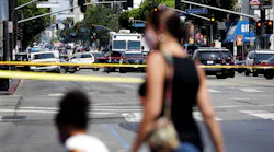 Pedestrians are turned around at the intersection of Hollywood Boulevard and Highland Avenue while Los Angeles police investigate an officer-involved shooting July 15.