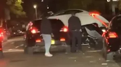 A man drive over an NYPD cruiser--using the hood as a ramp--to escape arrest Thursday.