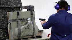 A worker at Point Blank Enterprises in Pompano Beach, FL, fires bullets into one of the company's bulletproof vests during a demonstration in 2018. A worker at Point Blank Enterprises in Pompano Beach, FL, fires bullets into one of the company's bulletproof vests during a demonstration in 2018.