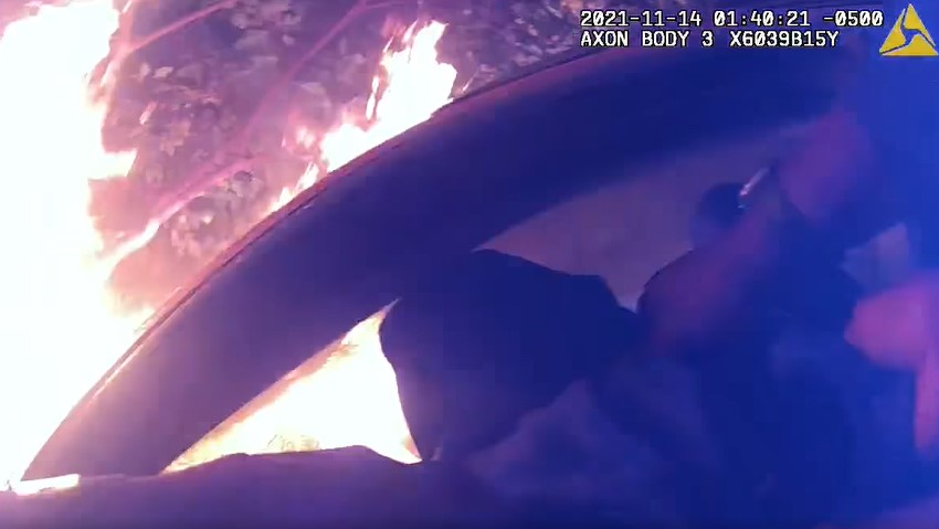 Atlanta police officers rescued a trapped driver Sunday from a car engulfed in flames after it went airborne and crashed into two houses and a car.