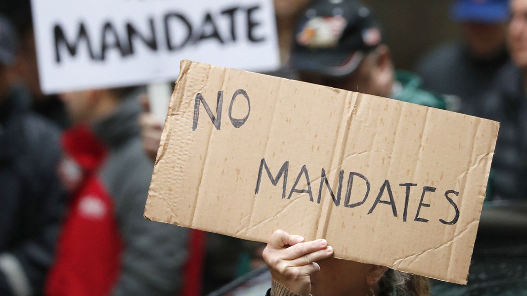 Members and supporters of the Fraternal Order of Police rally outside of City Hall in Chicago against the vaccine mandate for city workers Oct. 25.