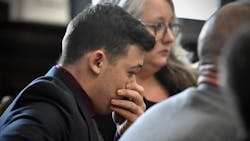 Kyle Rittenhouse puts his hand over his face as he is found not guilty on all counts at the Kenosha County, WI, Courthouse on Friday in Kenosha.