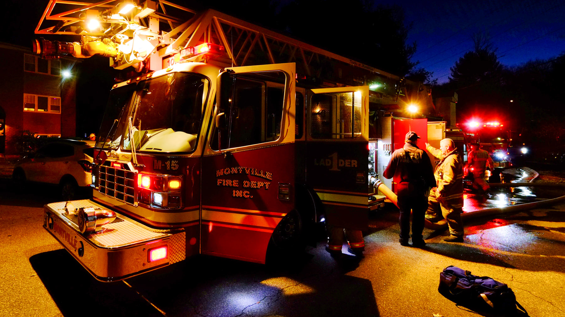Two Montville, CT, police officers got on top of their cruiser to rescue a boy hanging out of a second-story window of a burning apartment building Friday.