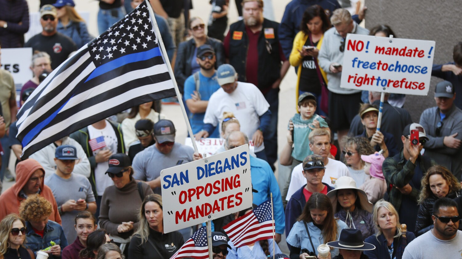 Law enforcement, firefighters and their families gathered for a news conference by ReOpen San Diego opposing vaccination mandates at the city's Civic Center Plaza in October.