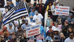 Law enforcement, firefighters and their families gathered for a news conference by ReOpen San Diego opposing vaccination mandates at the city's Civic Center Plaza in October. Law enforcement, firefighters and their families gathered for a news conference by ReOpen San Diego opposing vaccination mandates at the city's Civic Center Plaza in October.