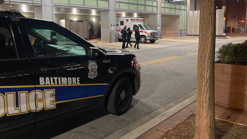 A Baltimore police cruiser is parked outside of Shock Trauma where an officer was being treated for multiple gunshot wounds following an ambush-style attack early Thursday.