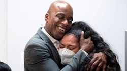 D&rsquo;Andre Lampkin, a Los Angeles County deputy sheriff and founder of the D&rsquo;Andre Lampkin Foundation, hugs Vanessa Coronado at the Ontario, CA, nonprofit&rsquo;s office on Wednesday.