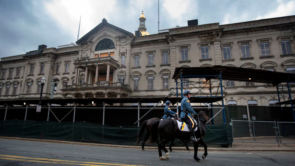 New Jersey State Troopers mounted on horseback walk the perimeter of the New Jersey Statehouse over the weekend. The statehouse is in the midst of a $300 million renovation project.