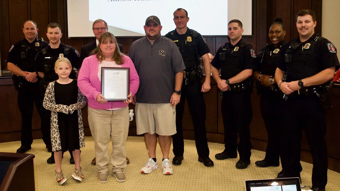 Allison Shellstrom stands next to North Augusta, SC, Public Safety Lt. Aaron Fittery after she was honored by city officials for helping Fittery after he had been wounded in a Dec. 9 shootout.