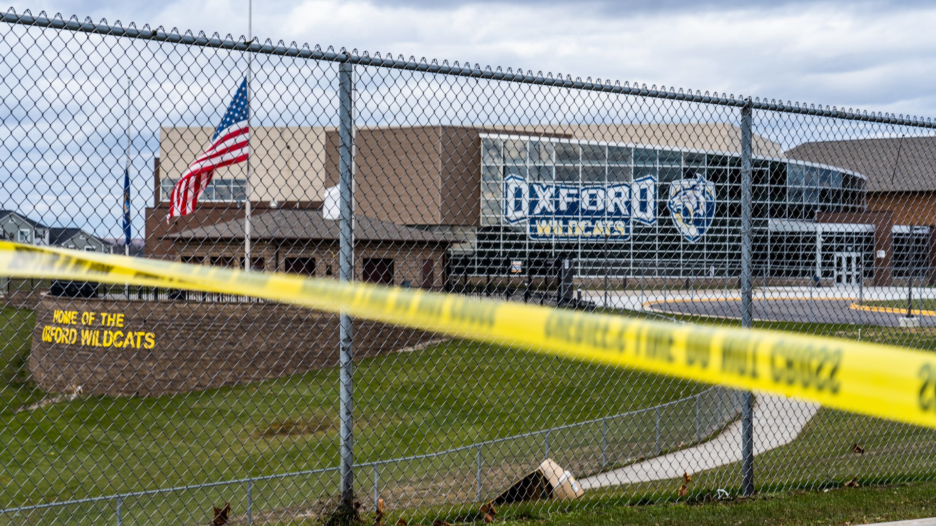 Flags wave at the rear entrance of Oxford, MI, High School on Dec. 2 after an active shooter situation Nov. 30 at the school that left four students dead and seven others with injuries.
