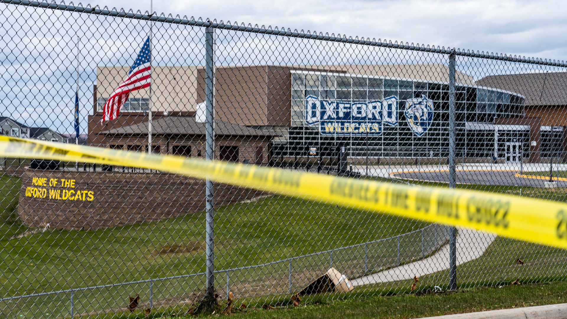 Flags wave at the rear entrance of Oxford, MI, High School on Dec. 2 after an active shooter situation Nov. 30 at the school that left four students dead and seven others with injuries.