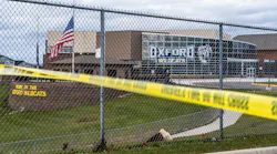 Flags wave at the rear entrance of Oxford, MI, High School on Dec. 2 after an active shooter situation Nov. 30 at the school that left four students dead and seven others with injuries.