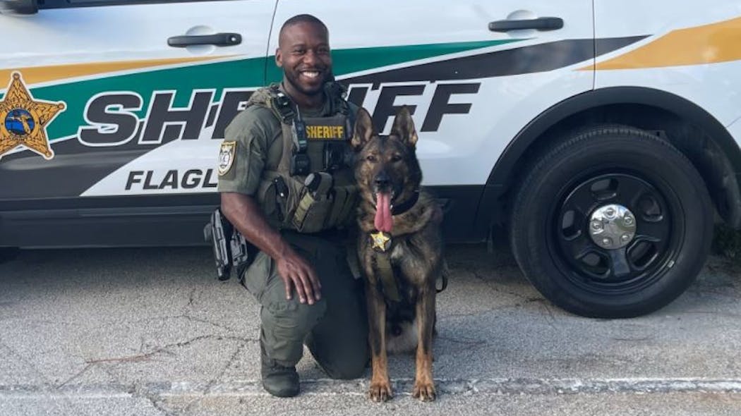 K-9 Deputy First Class Marcus Dawson is seen with his K-9 partner Baro