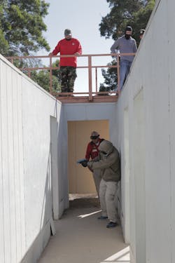 Building search skills are perishible and practice improves surviability. Here Lindsey (tan windbreaker) does a solo search for a suspect in a residence, while SGT Dan Gray instructs.
