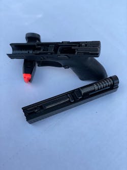 The CZ P-10S takedown is typical of most other striker-fired autos: After checking and double checking the gun is safe, pinch the two ends of the disassembly plate between two fingers, and pull down. It does take a pull of the trigger to release the slide forward.