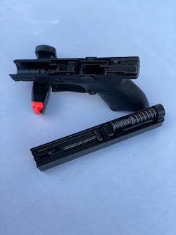 The CZ P-10S takedown is typical of most other striker-fired autos: After checking and double checking the gun is safe, pinch the two ends of the disassembly plate between two fingers, and pull down. It does take a pull of the trigger to release the slide forward. The CZ P-10S takedown is typical of most other striker-fired autos: After checking and double checking the gun is safe, pinch the two ends of the disassembly plate between two fingers, and pull down. It does take a pull of the trigger to release the slide forward.