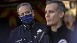 LAPD Chief Moore (left) watches as Mayor Eric Garcetti addresses a press conference held at Los Angeles Fire Station 3 on Thursday.