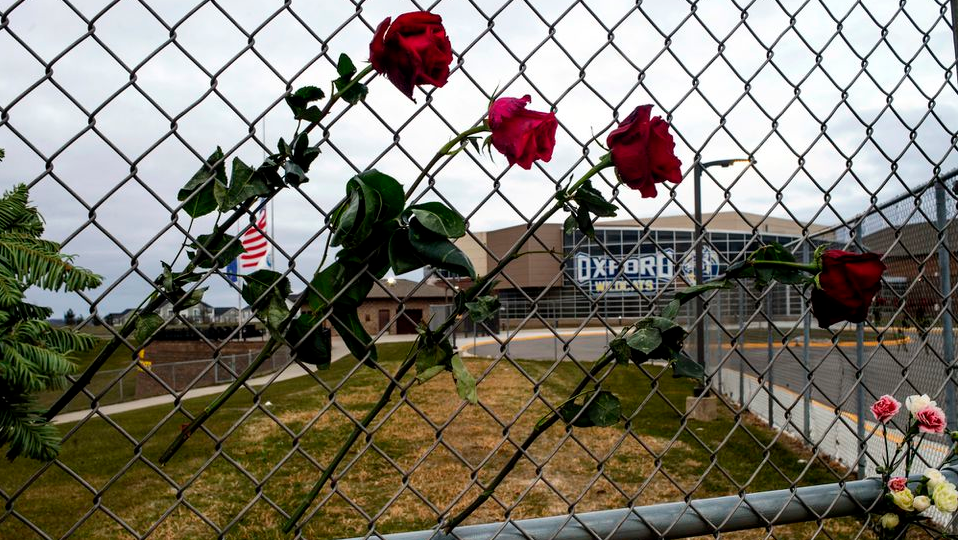 Four roses are placed on a fence outside Oxford, MI, High School to honor the four teens killed in a shooting at the northern Oakland County school Nov. 30.