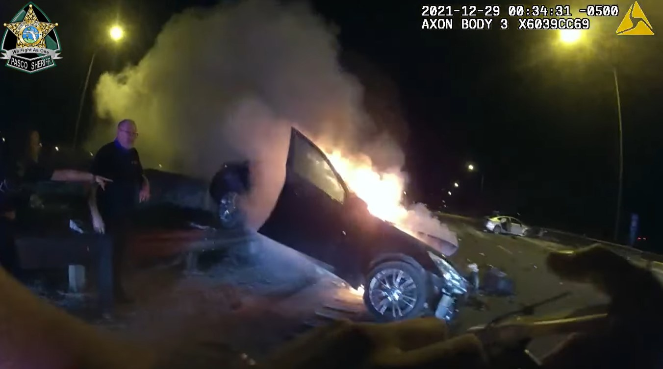 Pasco County, FL, Sheriff&rsquo;s Office deputies used fire extinguishers to put out flames before saving a woman who was trapped inside a crashed car that caught fire.
