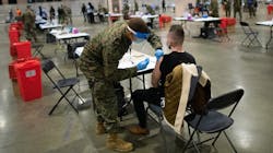 A member of the U.S. military administers a COVID-19 vaccine at a FEMA community vaccination center on March 2 in Philadelphia. A member of the U.S. military administers a COVID-19 vaccine at a FEMA community vaccination center on March 2 in Philadelphia.