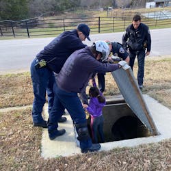 Southlake, TX, police officers rescue an 11-year-old girl who was trapped by snakes and a heavy inside a drainage pipe Wednesday. Southlake, TX, police officers rescue an 11-year-old girl who was trapped by snakes and a heavy inside a drainage pipe Wednesday.