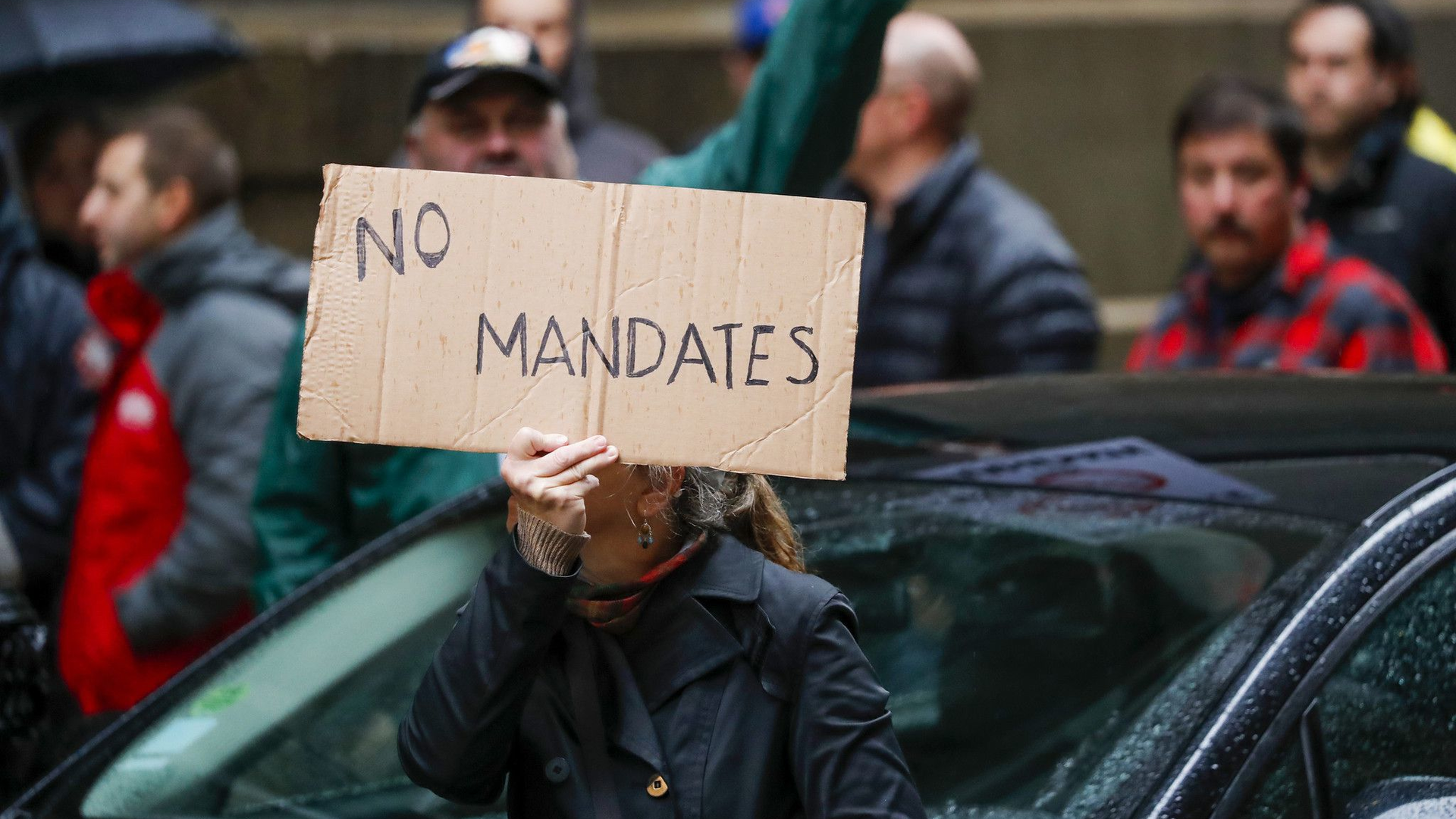 Members of the Fraternal Order of Police and supporters rally outside of City Hall in opposition to the COVID-19 vaccine mandate for city workers.