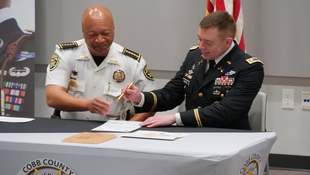 Cobb County, GA, Sheriff Craig Owens (left) and Lt. Col. David Hensel, commander of the U.S. Army Atlanta Recruiting Battalion, signed a new partnership to help the agency recruit former soldiers.