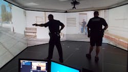 Two officers take part in a Law Enforcement Dog Encounters Training program (LEDET) scenario in VirTra&apos;s training simulator.
