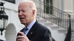 President Joe Biden speaks to members of the press before a Marine One departure from the White House on March 23.