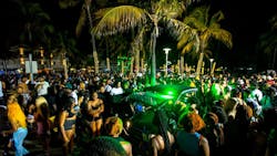 A Miami Beach police vehicle cuts through crowds near Ocean Drive during spring break Saturday. A Miami Beach police vehicle cuts through crowds near Ocean Drive during spring break Saturday.