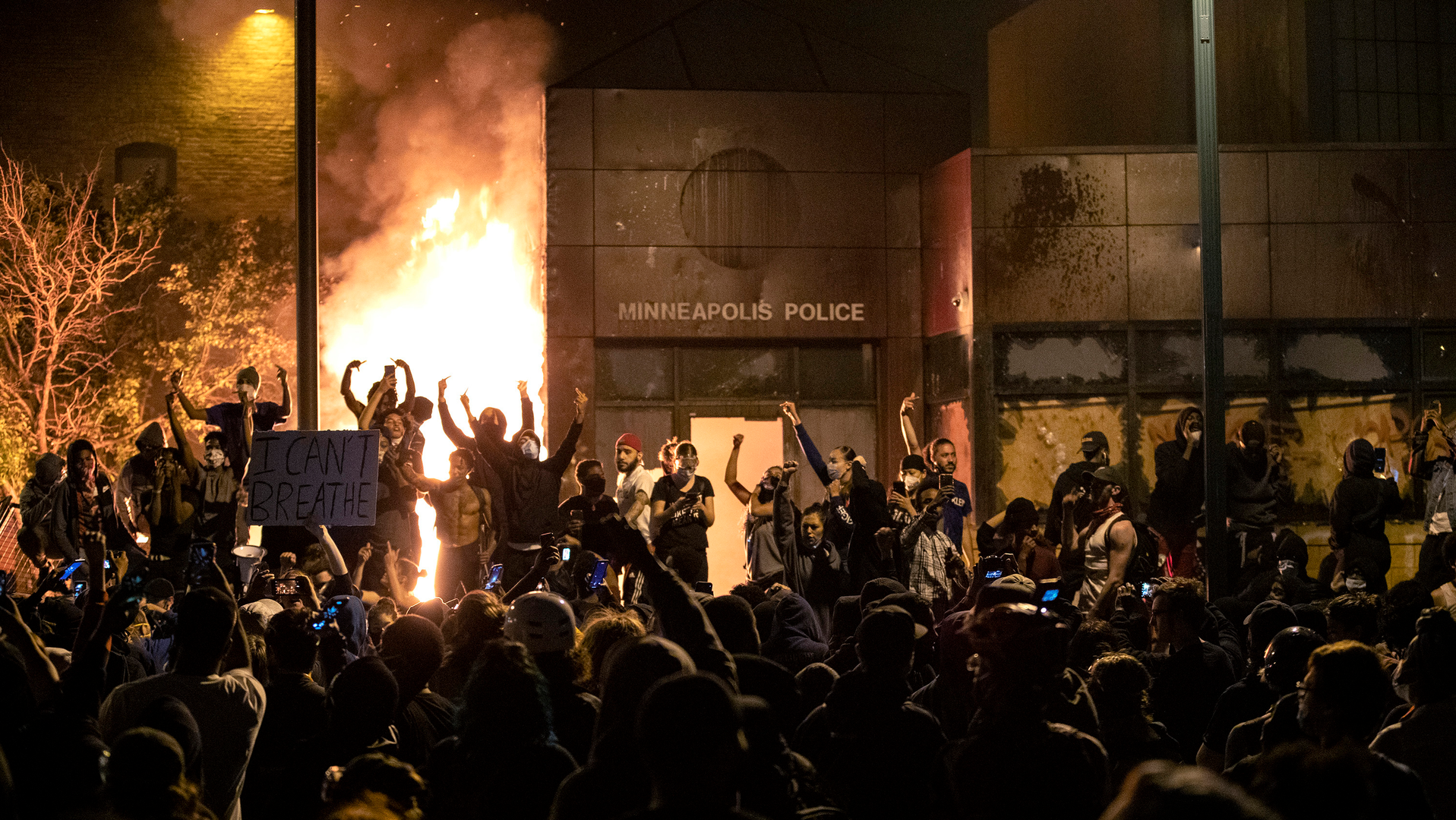 The Minneapolis Third Police Precinct is set on fire during a third night of protests following the death of George Floyd in May 2020.