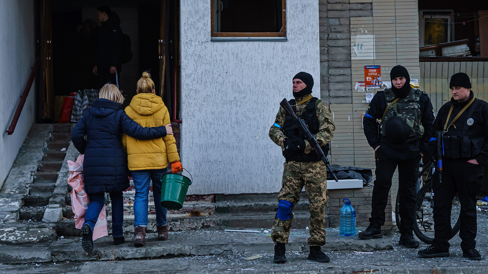 Residents remove debris from a damaged residential building Thursday in Kyiv, Ukraine.