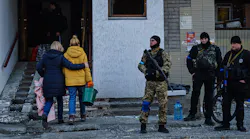 Residents remove debris from a damaged residential building Thursday in Kyiv, Ukraine.