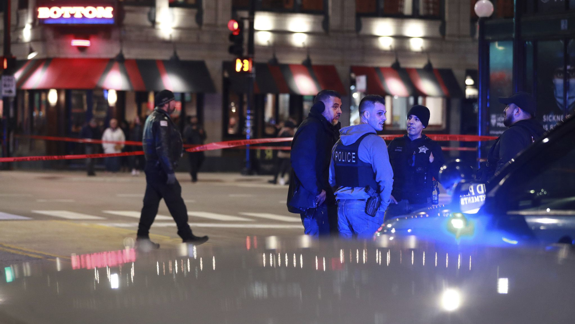 Chicago police work the scene at Grand and State in Chicago's Near North neighborhood after an accident involving a police officer on April 9, 2022.