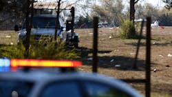 A police car sits in front of the scene where 18 people were shot and one person was killed Saturday at a concert in the Dallas neighborhood of Oak Cliff. A police car sits in front of the scene where 18 people were shot and one person was killed Saturday at a concert in the Dallas neighborhood of Oak Cliff.