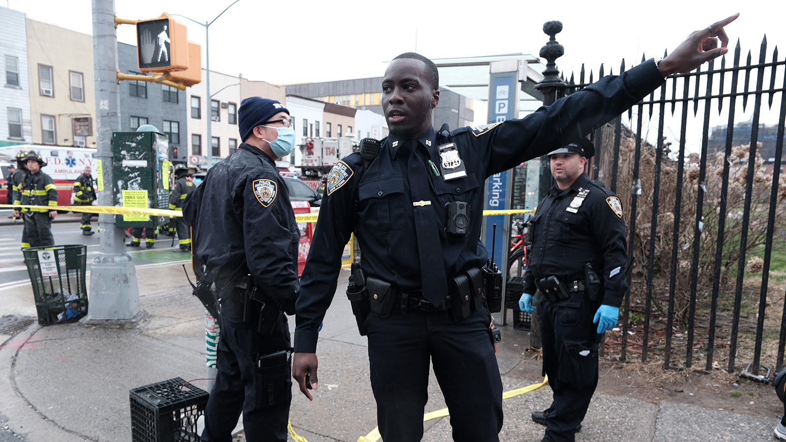 Police and emergency responders gather at the site of a shooting of at least five passengers aboard a New York City subway train Monday.