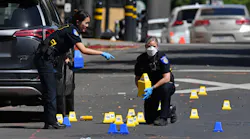 Sacramento police crime scene investigators place evidence markers at the scene of a mass shooting that left six people dead and 12 injured early Sunday.