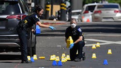 Sacramento police crime scene investigators place evidence markers at the scene of a mass shooting that left six people dead and 12 injured early Sunday. Sacramento police crime scene investigators place evidence markers at the scene of a mass shooting that left six people dead and 12 injured early Sunday.