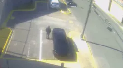 The chief deputy for the Walker County, AL, Sheriff's Office is seen in security camera footage spotting a man allegedly tying a drug-filled sock to the fence of the jail Tuesday.