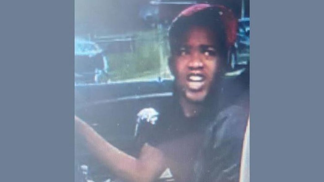 Brighton, AL, police are trying to identify a suspect who is accused of driving up to the funeral of a Birmingham murder victim with a gun in his lap.