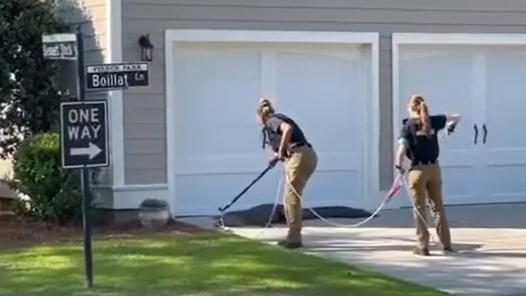 Two officers from the Charleston, SC, Police Department's Animal Control Unit wrangled an alligator that wandered close to a school Monday.